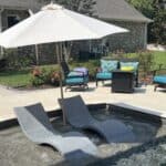 Picture of a ledge lounger and umbrella.